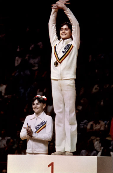  Romanian Nadia Comaneci, aged 14, celebrates winning gold in the women¿s uneven bars at Montreal in 1976.