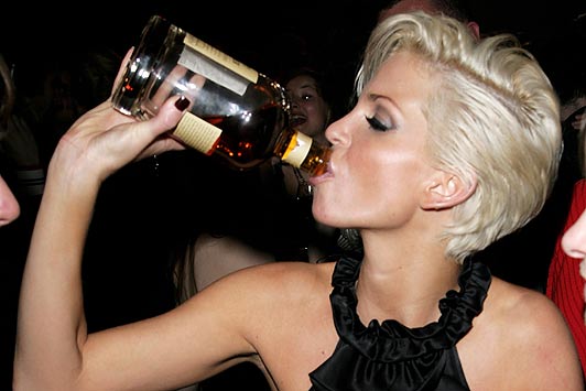 Girls Aloud member Sarah Harding drinks from a bottle of scotch whisky at the party following the Shockwaves NME awards at the Hammersmith Palais on March 1, 2007 in London,