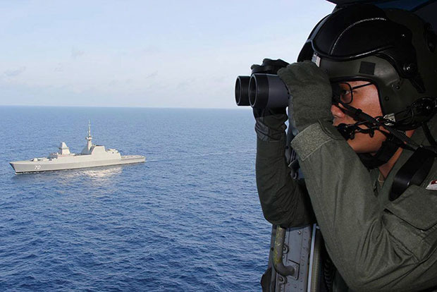 Republic of Singapore Navy's Facebook page, shows air crew from the the Republic of Singapore Air Force on board a naval helicopter conducting a surface search for the missing flight MH370 during ongoing efforts to locate the missing Malaysia Airlines plane in search operations of pre-assigned sectors 380 nautical miles (700 km) North of Singapore.