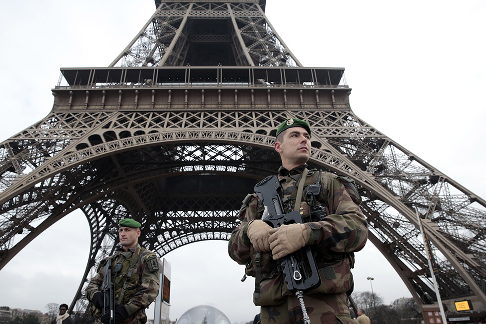 rench soldiers patrol in front of the Eiffel Tower on January 7, 2015 in Paris as the capital was placed under the highest alert status after heavily armed gunmen shouting Islamist slogans stormed French satirical newspaper Charlie