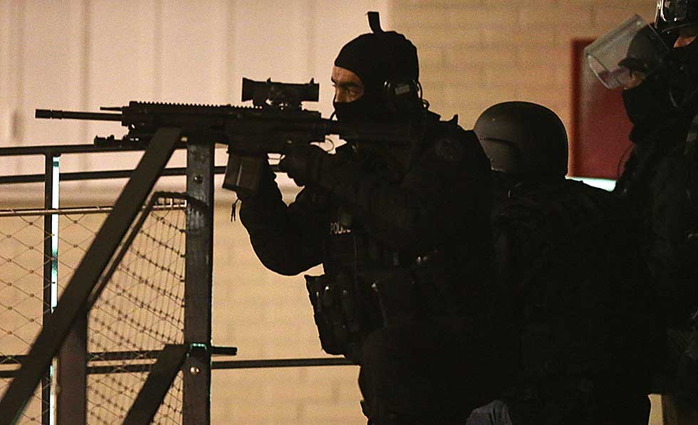 Police are seen during an operation in the "Croix-Rouge" suburb of Reims, northern France early January 8, 2015 following the attack on satirical weekly Charlie Hebdo that left 12 dead in Paris. French police are hunting three men, including two brothers, suspected of carrying out the attack , a source close to the investigation told AFP.