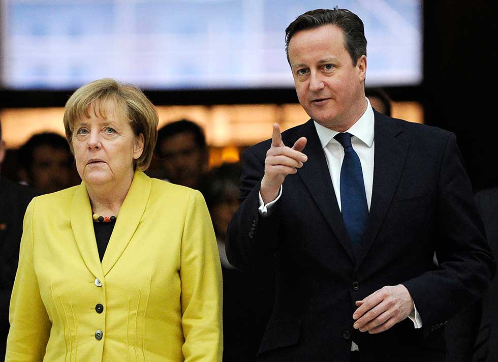 Britain's Prime Minister David Cameron (R) accompanies German Chancellor Angela Merkel as they visit the British Museum in London January 7, 2015.