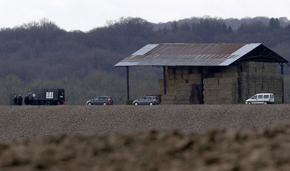 French armed police officers patrol near a farm as they search for suspects in Wednesday's attack at the Paris offices of the newspaper Charlie Hebdo, in Longpont, northeast of Paris, Thursday, Jan. 8, 2015. Masked gunmen stormed the Paris offices