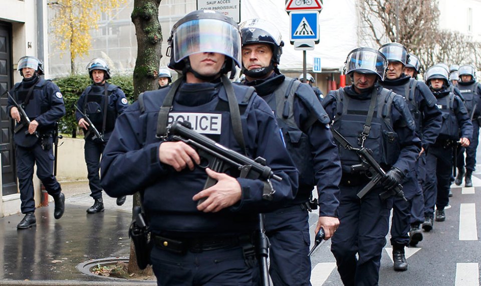  Armed cops take up positions were forced to raid a kosher supermarket that was raided only days after the Charlie Hebdo attack