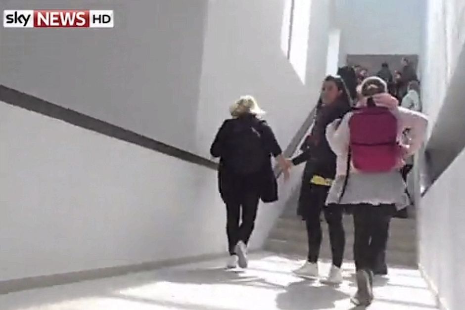 Visitors flee up a flight of stairs