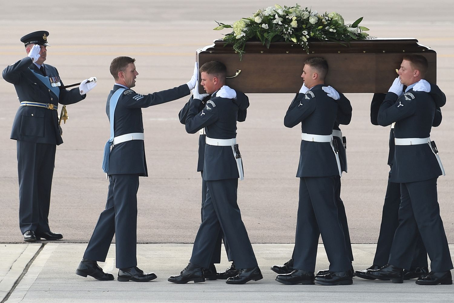 Airman's salutes as the coffins are removed