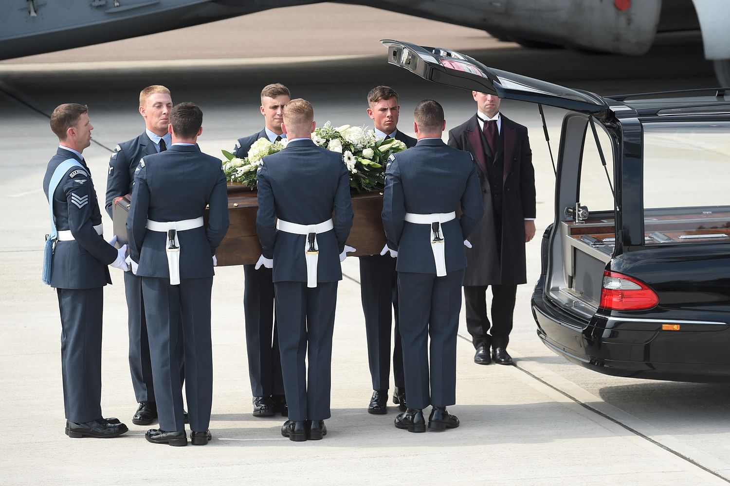 Coffins are transferred to hearses