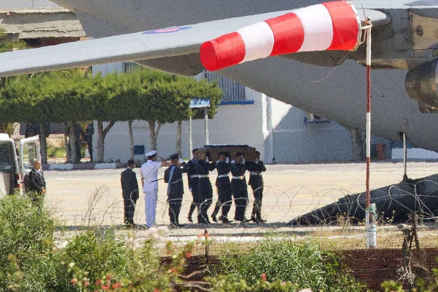 One of the coffins is carried on to the C-17 plane in Tunisia