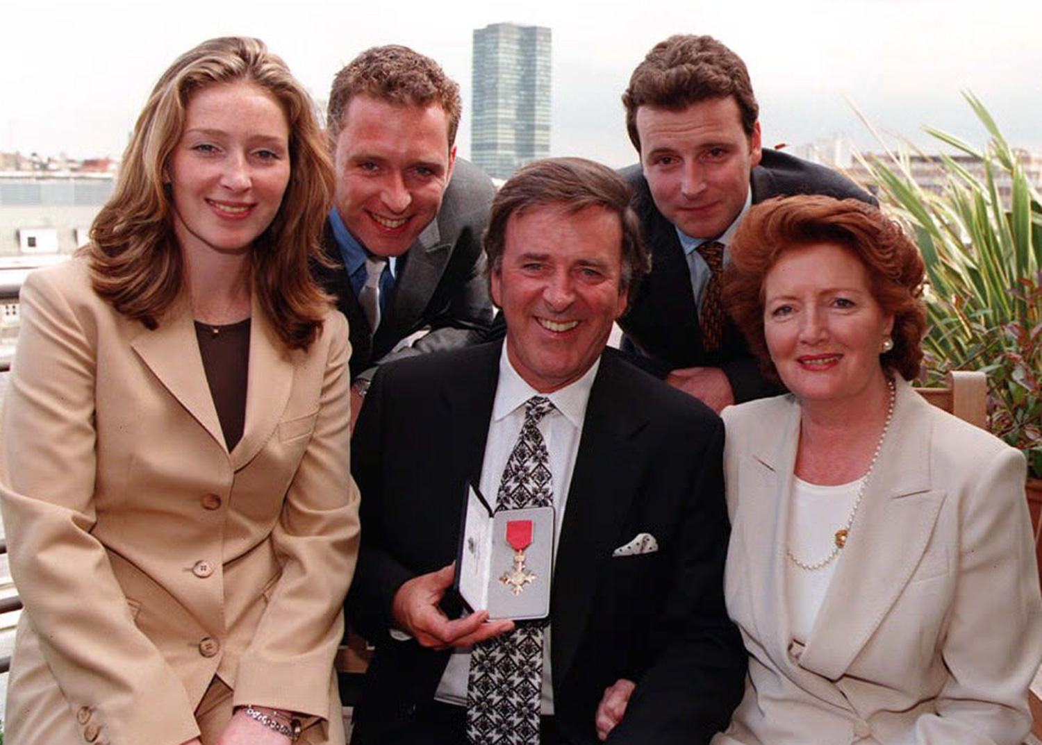 d Radio 2 presenter Terry Wogan, with his wife Helen, daughter Katherine, and sons Mark (right) and Alan, after he was presented with an Honorary OBE today (Friday), by National Heritage Secretary Chris Smith, at Broadcasting House in London. Photo by BBC. See PA Story SHOWBIZ Wogan.