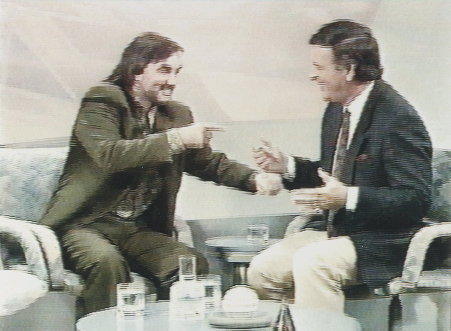 videograb from the BBC television programme 'Wogan', a chat show hosted by Terry Wogan (right). George Best (left) was a guest on the show but as soon as he appeared it was obvious he was extremely drunk, which is not really surprising as he had been drinking for four hours in the green room before going on stage. He slurred and swore his way through the show, which brought a flood of complaints, and had to be carried from the studio and lifted into a car. OPS Wogan laughing as Best points at him whilst they are chatting Date: 19.09.1990