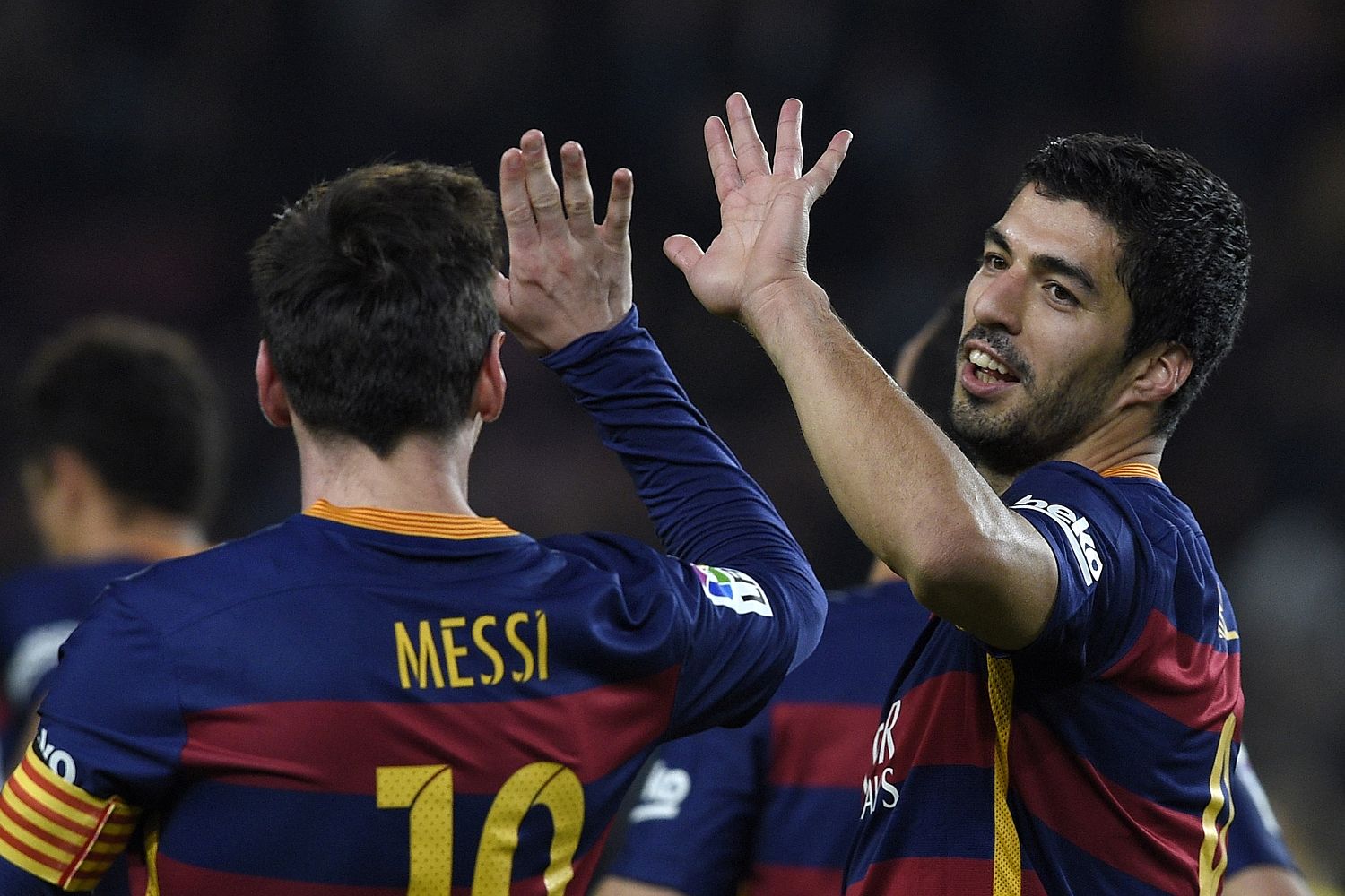 Messi and Suarez high five after their demolition job