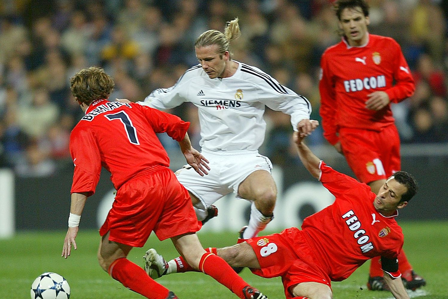 David Beckham and Ludovic Giuly challenge for the ball as Real Madrid hammer Monaco