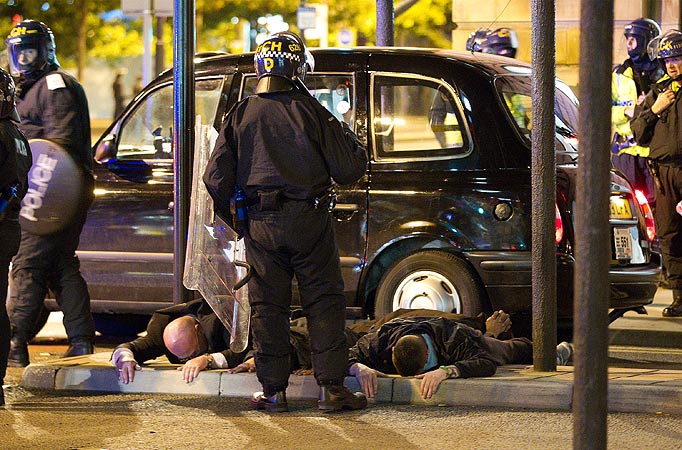 Police detain people late in to the night and through the early morning in and around Manchester City Centre.