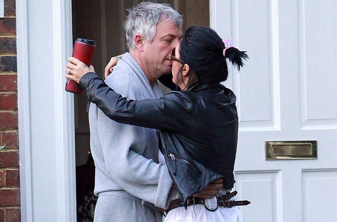 British EastEnders actress Jessie Wallace shares a passionate kiss with her fiancee Vincent Morse on the doorstep of his Surrey home, having spent the night there.