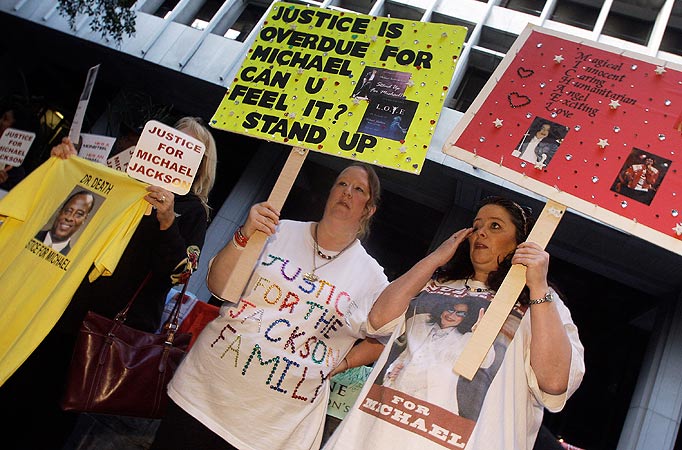 Demonstrators make their case on the sidewalk as the involuntary manslaughter trial for Dr. Conrad Murray, Michael Jackson's personal physician when the pop star died, gets underway at the Criminal Justice Center in Los Angeles