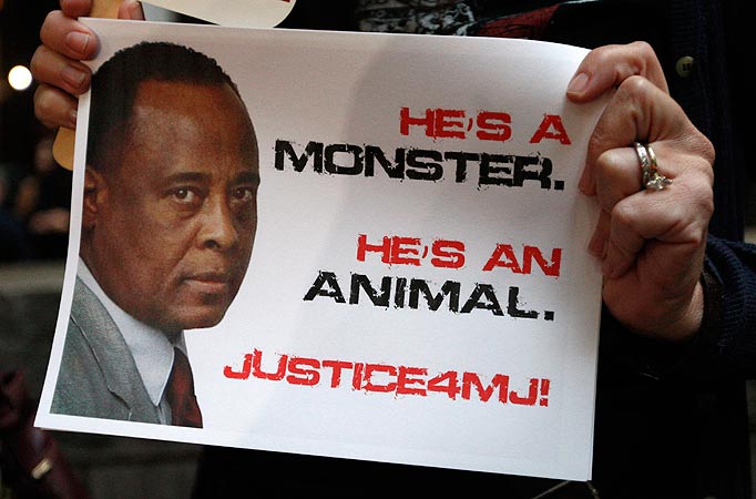 Demonstrators make their case on the sidewalk as the involuntary manslaughter trial for Dr. Conrad Murray, Michael Jackson's personal physician when the pop star died, gets underway at the Criminal Justice Center in Los Angeles