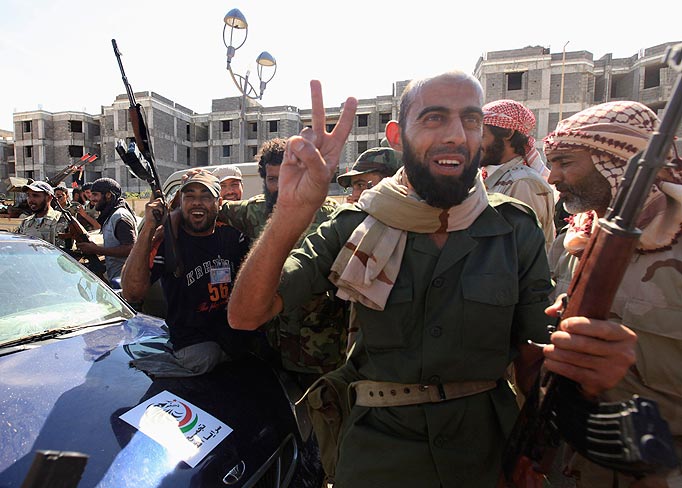 Anti-Gaddafi fighters celebrated the fall of Sirte October 20, 2011. Libyan interim government fighters captured Muammar Gaddafi's home town on Thursday, extinguishing the last significant resistance by forces loyal to the deposed leader and ending a two-month siege.