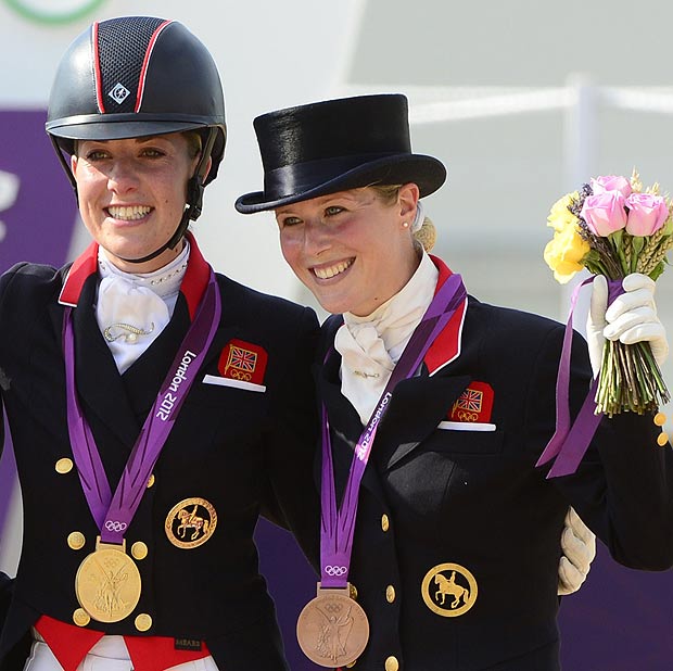 Britain's Charlotte Dujardin (C) with the gold medal