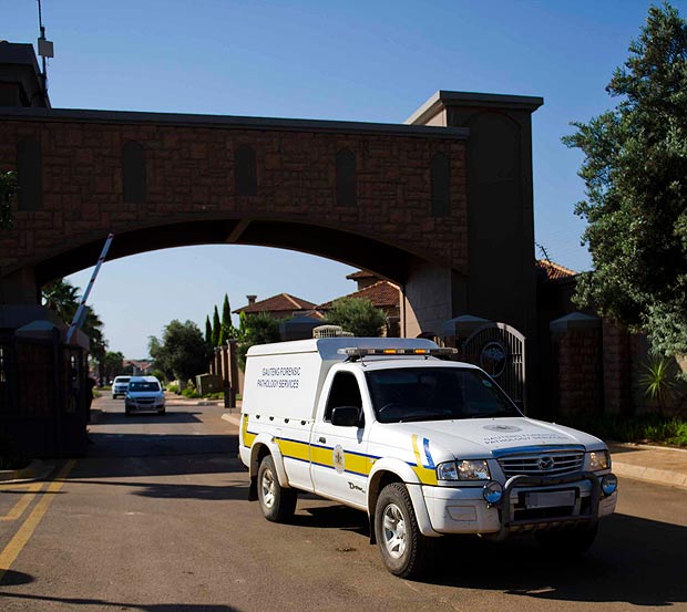 A forensics van leaves the housing estate where Olympian Oscar Pistorius lives,