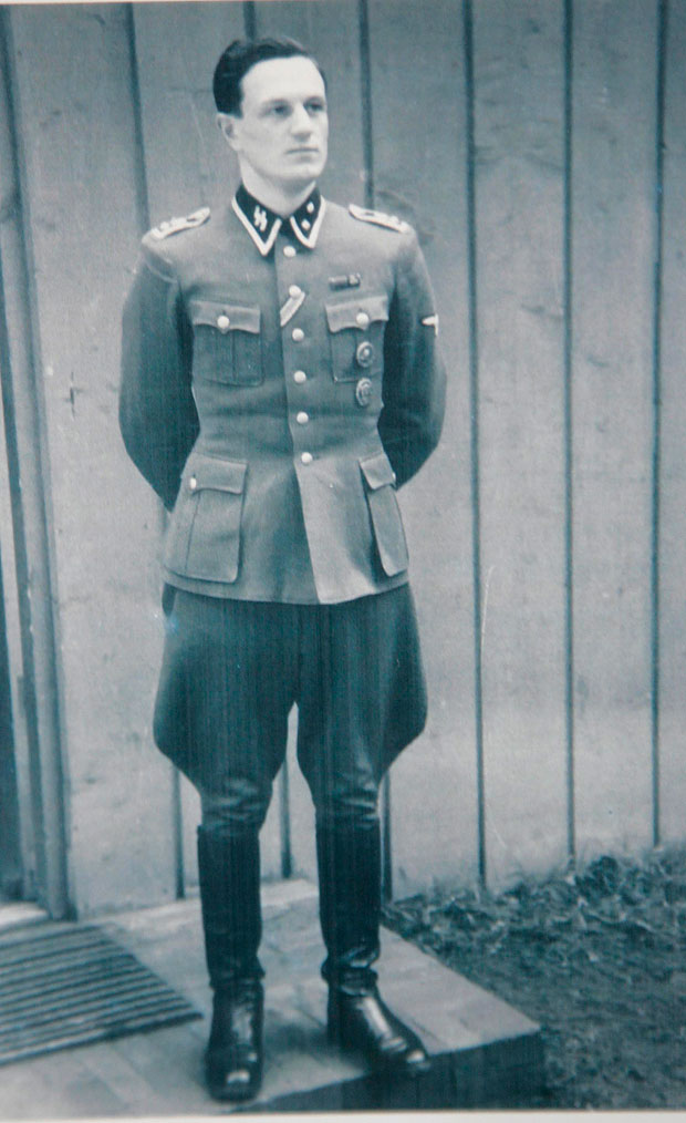 ROCHUS MISCH the former body guard and Telephone operator to Adolf Hitler with a picture of Misch at Wolfs Lair in 1944