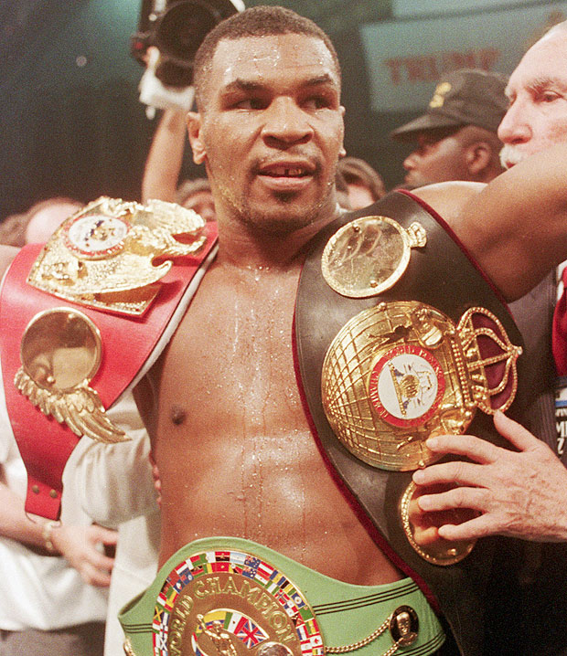 n: 27 Jun 1988, Atlantic City, New Jersey, USA --- 6/27/1988-Atlantic City, NJ- Unquestionably the heavyweight champion of the world, Mike Tyson shows off his 3 championship belts- the WBC, WBA, and IBF -after knocking out Michael Spinks in the first round 6/27 of their title bout. --- Image by © Bettmann/CORBIS