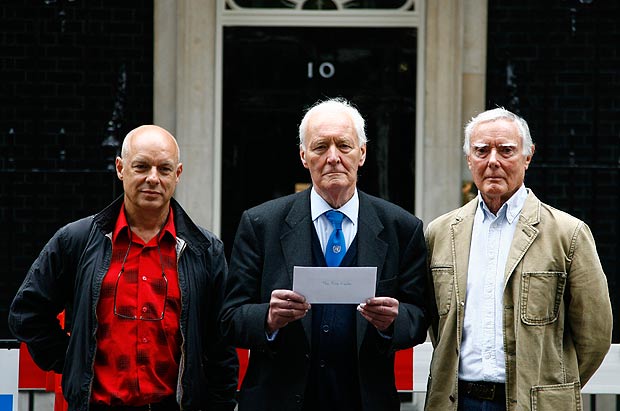 Members of the Stop the War Coalition, (L-R) music producer Brian Eno, Tony Benn and artist Brian Gentleman, pose with a letter of concern