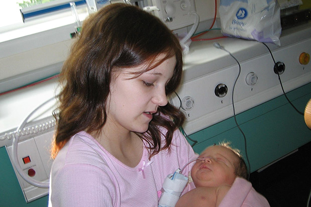 : Headline: MUM, 12 & BABY IN CARE
*** WARNING: Girl's face was pixellated in published version
Caption: PLEA ... 12yr old mum and tot
12-year-old Tressa Middleton with her newborn daughter Toni. Pic: Les Gallagher