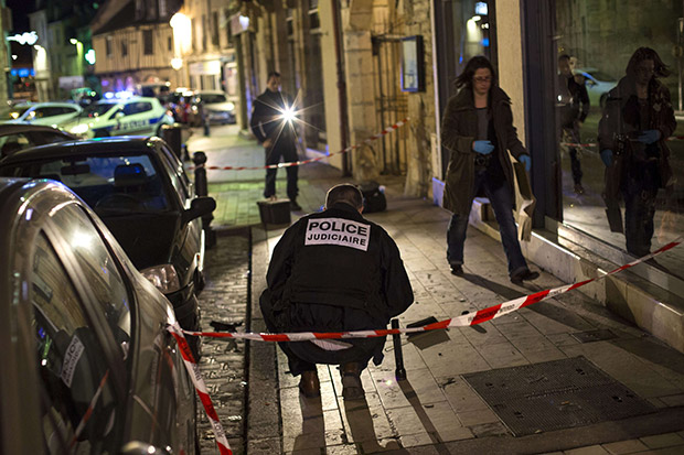 Policemen collect evidence on December 21, 2014 i