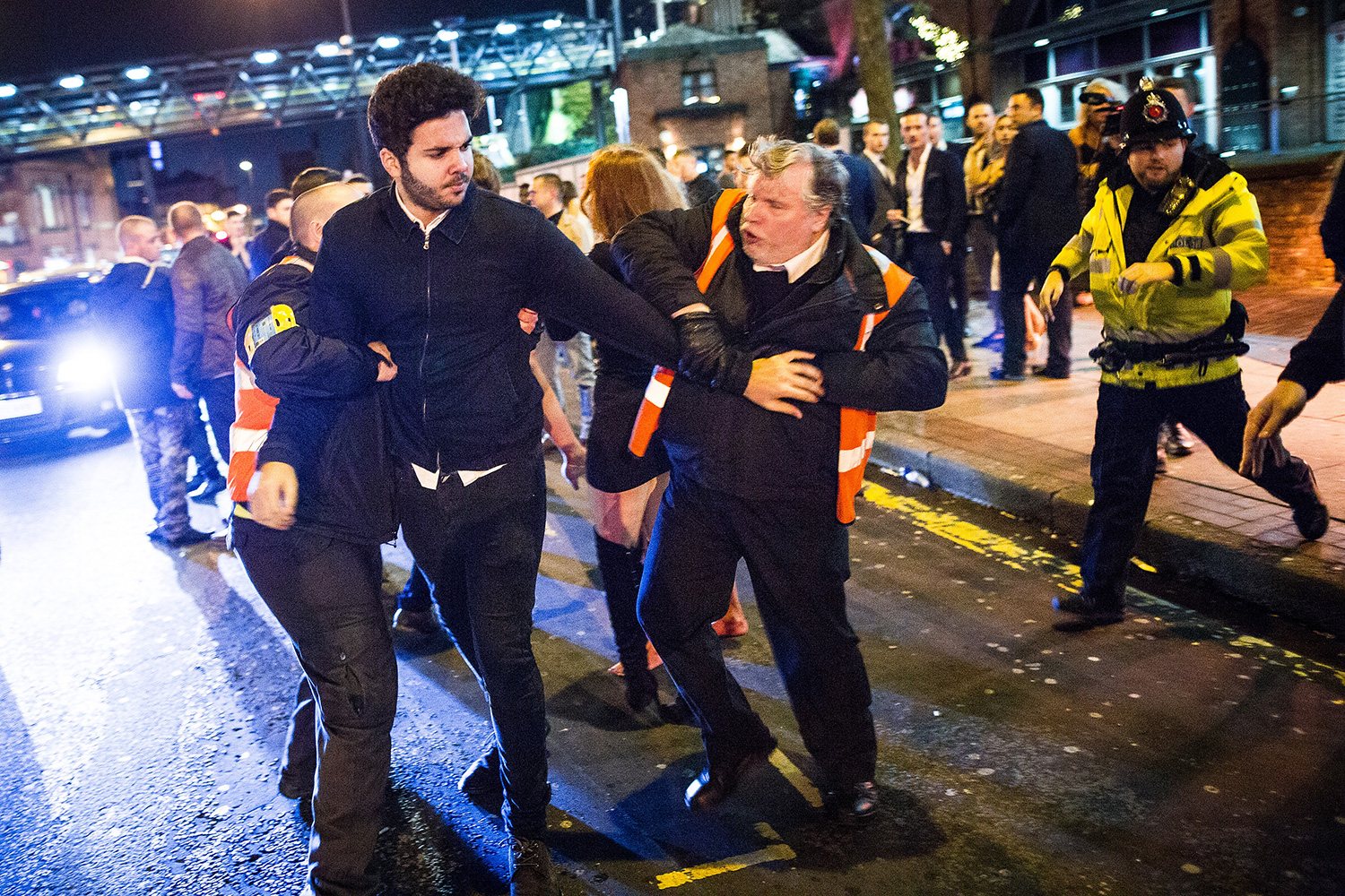 rivate security detain a man after another man is punched , at Deansgate Locks . Revellers in Manchester enjoy " Mad Friday " - also known as " Black Eye Friday " - the day on which emergency services in Britain are typically at their busiest , as