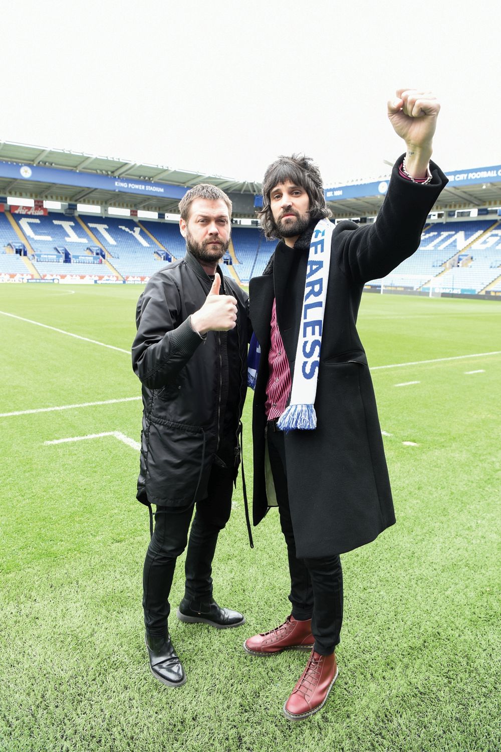 Serge with bandmate and frontman Tom Meighan on the football pitch