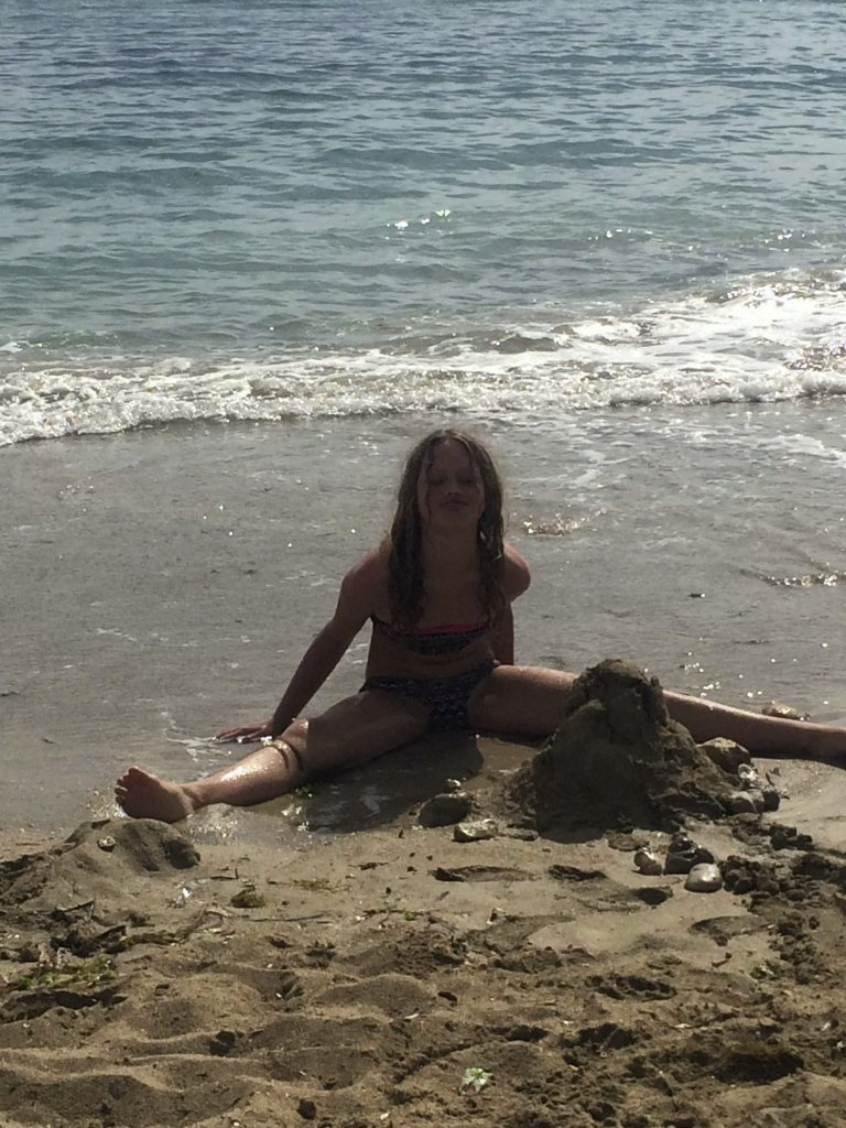  Waves lap round Amelia as she poses on an Ibiza beach on break which meant she missed nine days of term