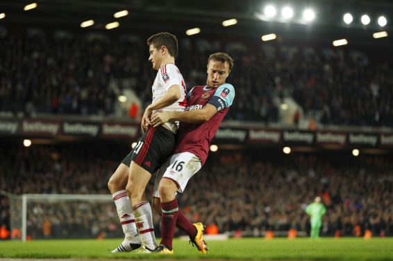  Noble cause ... West Ham star Mark takes Man Utd matters into his own hands