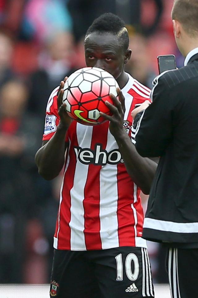 Sadio Mane kisses the match ball after netting a hat-trick against Manchester City 