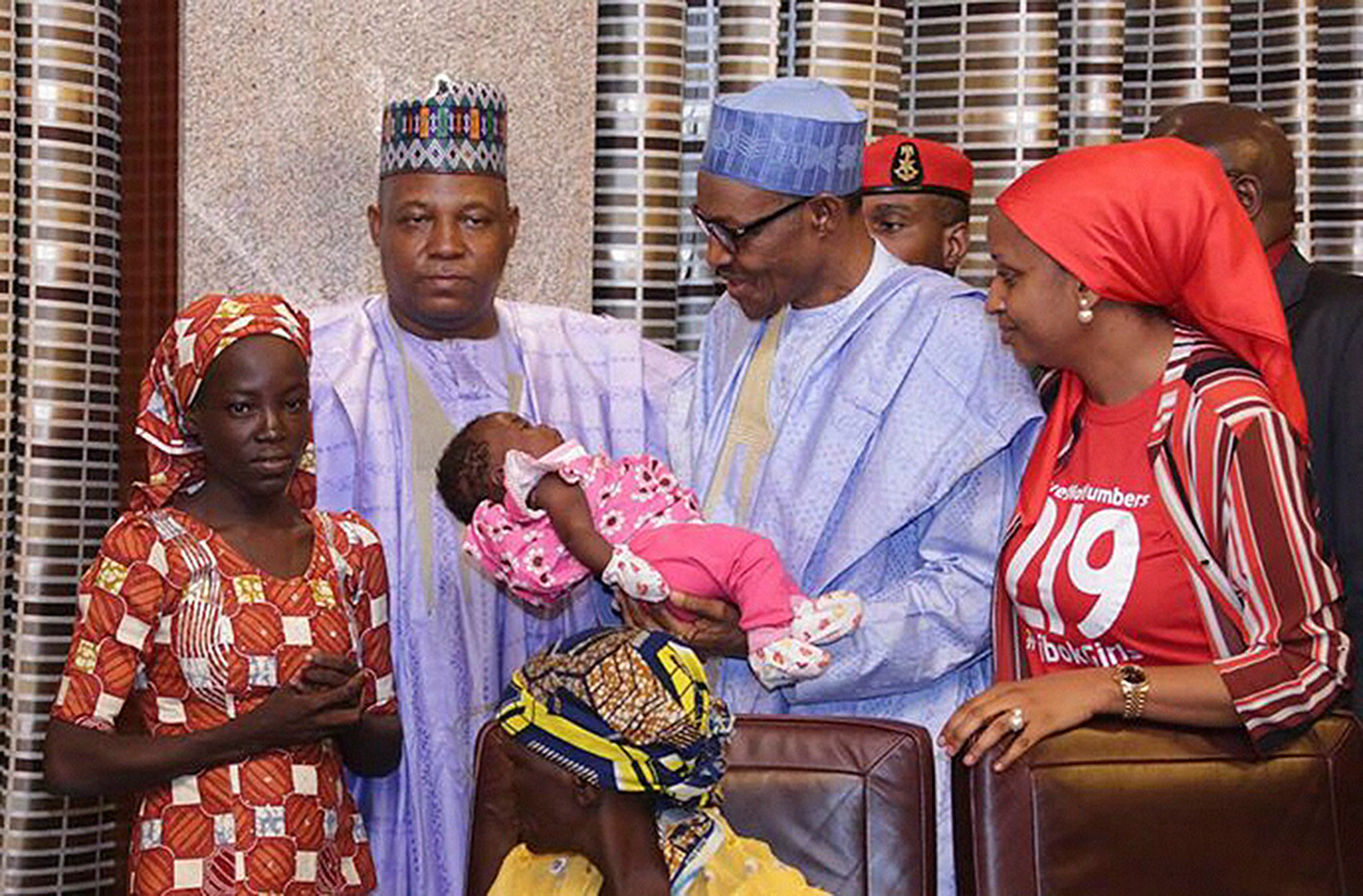 epa05317322 Nigerian President Muhammadu Buhari (2-R) meets with rescued girl Amina Ali Nkeki and baby (L) with Governor Kashim Shettima of Borno State (C) at the presidential villa in Abuja, Nigeria, 19 May 2016. Amina Ali Nkeki was found in the Sambisa Forest near the border of Cameroon. Nigerian Military found her carrying a baby and with a suspected member of the Boko Haram Islamist group. 218 girls remain missing after their abduction from Chibok secondary school in north-east Nigeria in 2014. EPA/STRINGER