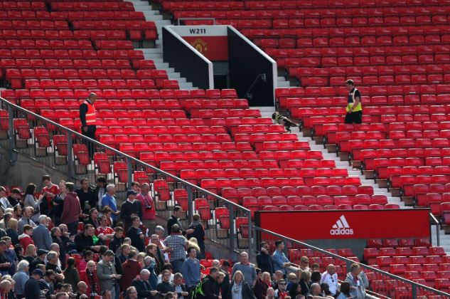  Threat ... sniffer dog patrols the stands after fans were evacuated from the ground