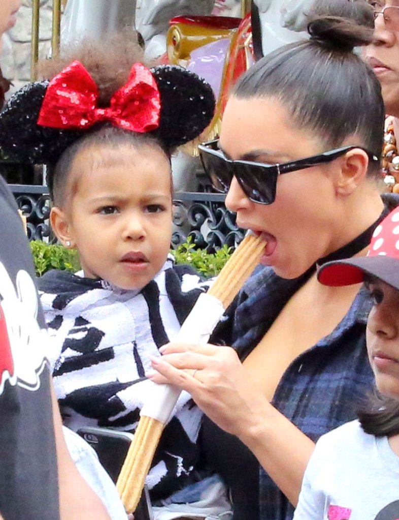  Kim's strict diet went out the window at Disneyland as she treated herself to a sugary fried churro