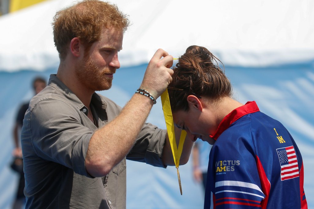 Prince Harry kissed Marks on the cheek after presenting her with the medal yesterday