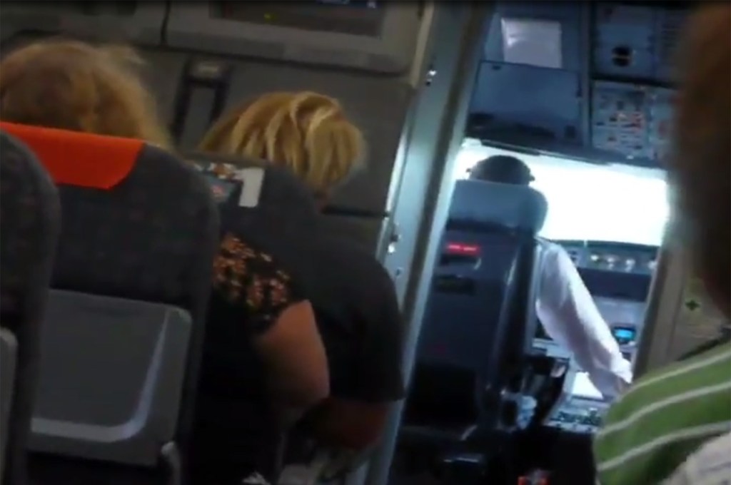  Passengers aboard the flight could be seen craning their necks to look inside the cockpit