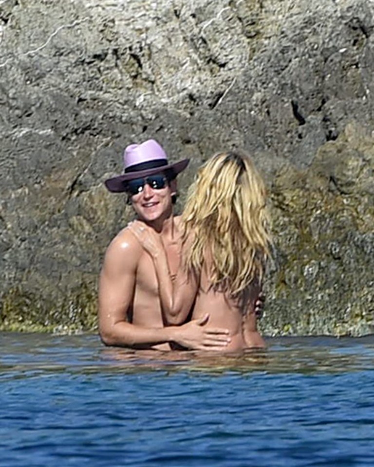 Heidi's art collector beau seems to have an eye for his assets as he plays with his girlfriend in the sea