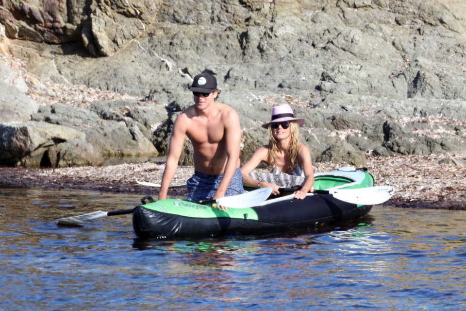 The playful couple took a rubber dinghy out to see before returning to their fancy yacht