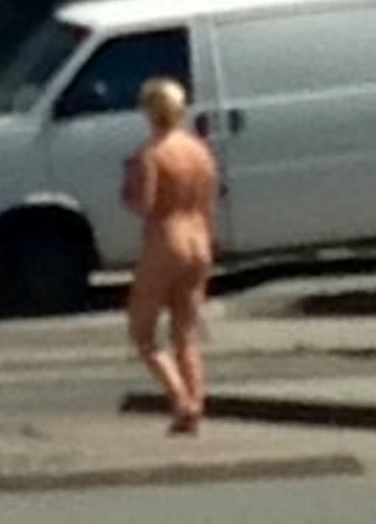  A woman takes a stroll completely naked through the streets of Newquay, Cornwall after a spray tan