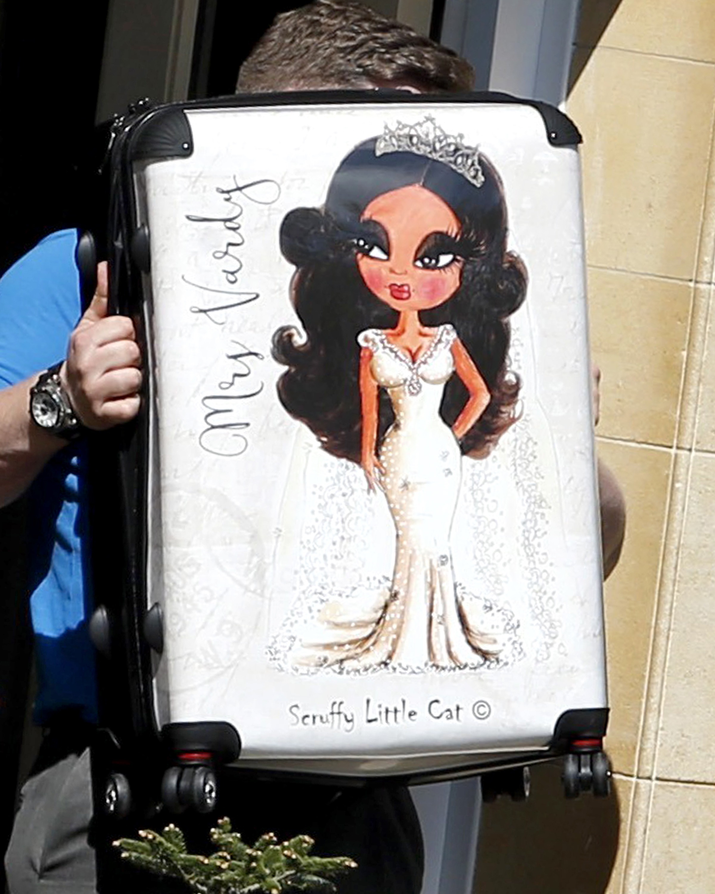  Former nighclub PR girl showed she was ready to take on her future hubby’s famous name after setting off from her home in Leicestershire yesterday with personalised luggage