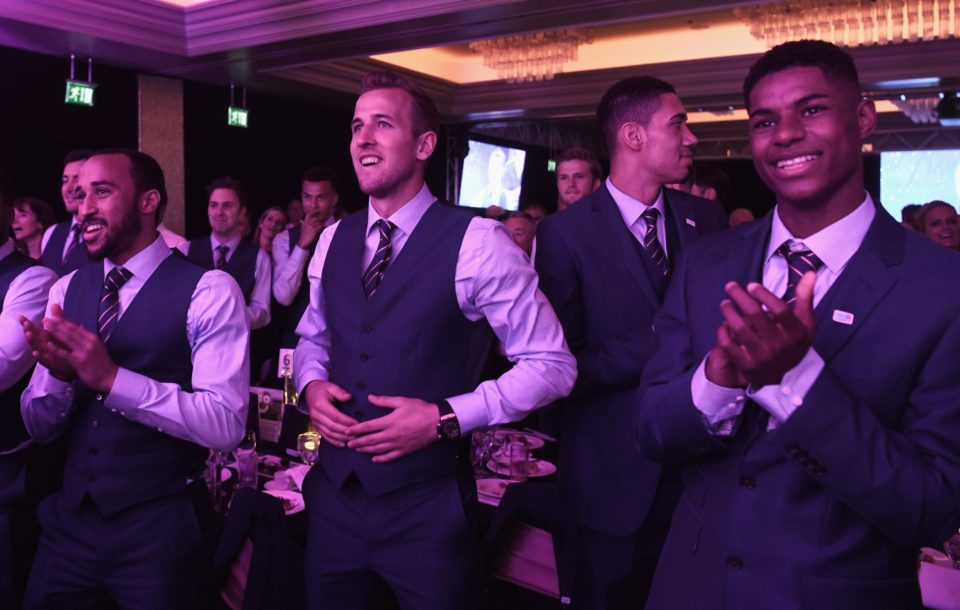  Giggles ... Andros Townsend, Harry Kane, Chris Smalling and Marcus Rashford look on as Wayne Rooney and James Bay perform