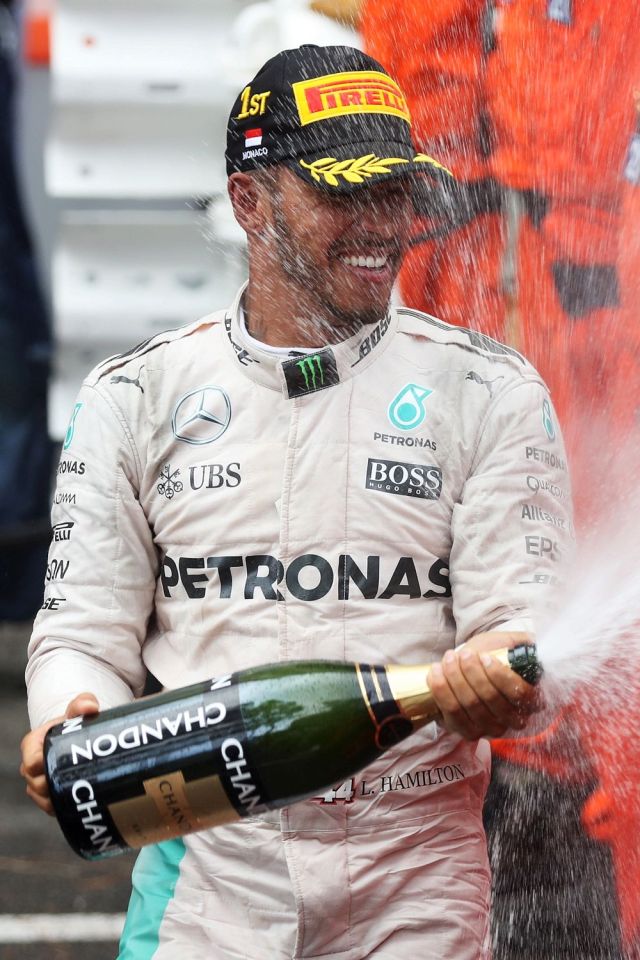 Lewis Hamilton celebrates his victory in Monaco with a blast of champagne 