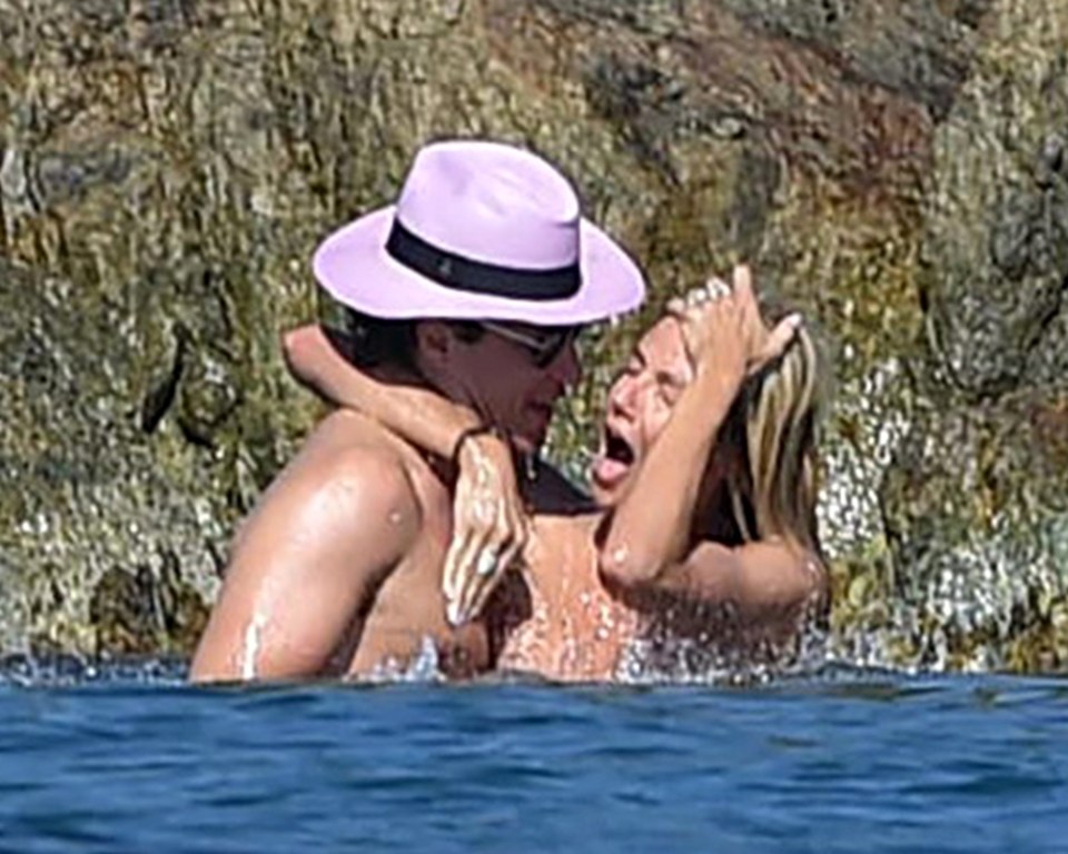 Heidi yelps in delight as she frolics with Vito on a quiet part of the beach