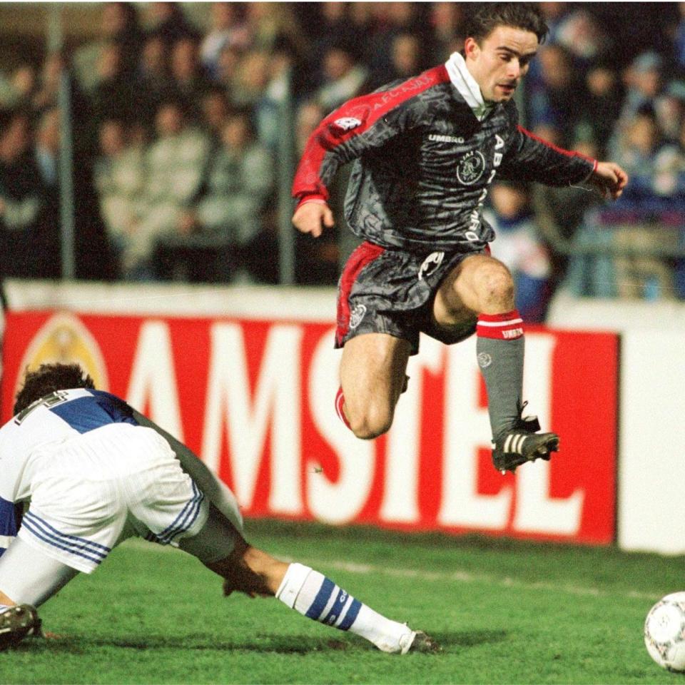  Speedy Marc Overmars leaves an opponent for a dead as he races with the ball