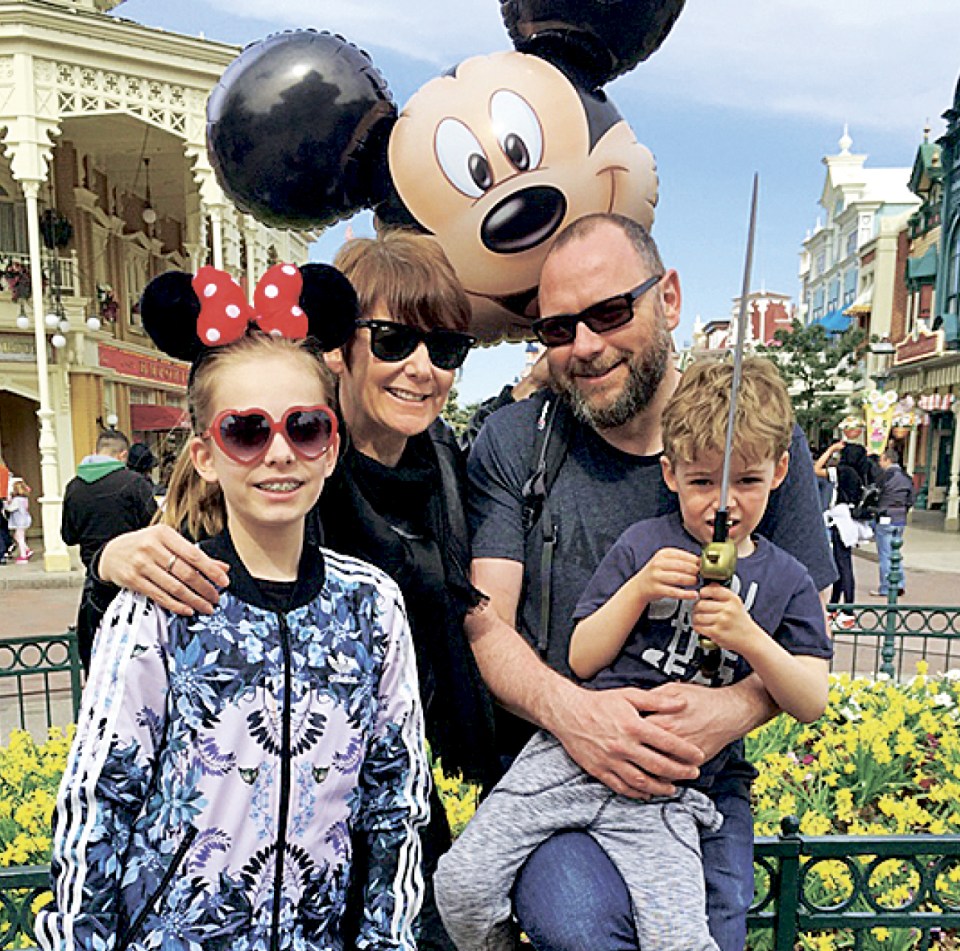  Fashion Director Tracey and her family pose with Mickey at Disneyland Paris