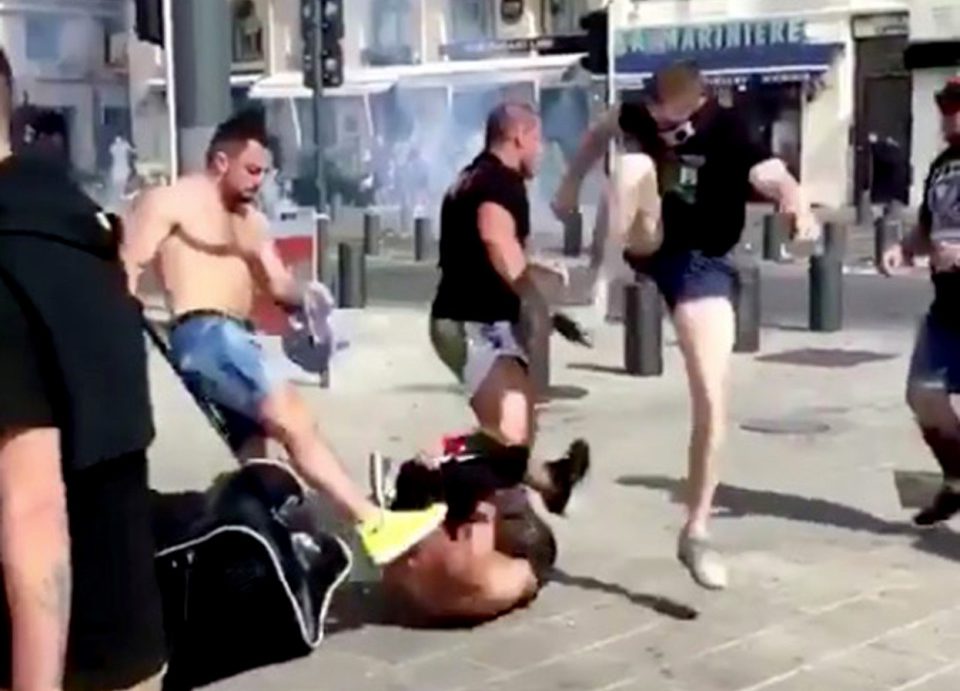 Pic posted on social media shows: What appears to be black shirted Russian fighting with England fans in Marseille. One man in a black shirt aims a kick at the head of an England fans on the pavement, followed by a punch. His friend then leaps up and lands another sickening kick whilst he is on the floor. Picture by Pixel8000 07917221968