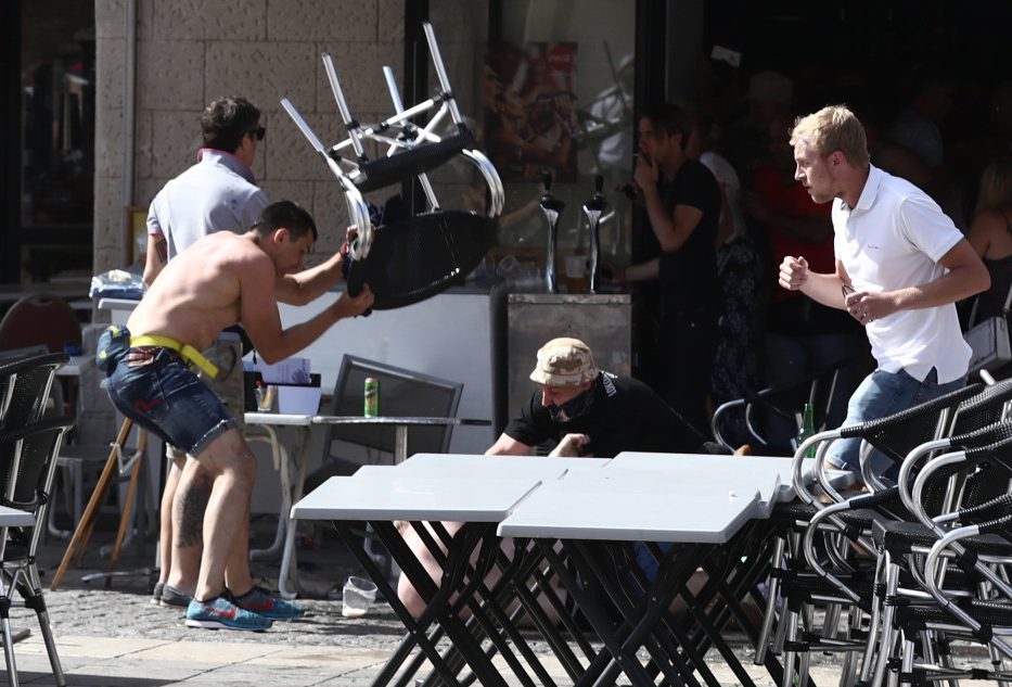 MARSEILLE, FRANCE - JUNE 11: A Russian fan smashes a chair over an England supporter as another attacks him on the ground as they clash ahead of the game against Russia later today on June 11, 2016 in Marseille, France. Football fans from around Europe have descended on France for the UEFA Euro 2016 football tournament. (Photo by Carl Court/Getty Images)