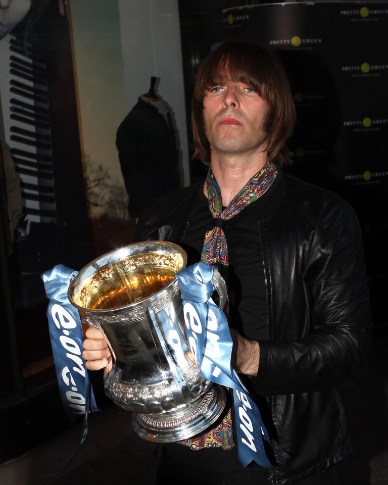  Manchester City fan Liam Gallagher seen here with his very own sideburns and with his hands on the FA Cup after his club had won it at Wembley